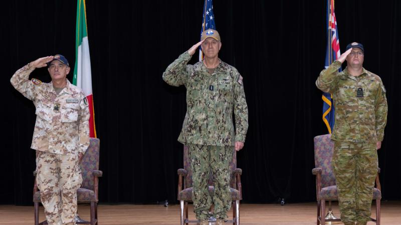 From left, Italian Navy Captain Roberto Messina, Vice Admiral George Wikoff and Royal Australian Navy Captain Jorge McKee during a change-of-command ceremony in Manama, Bahrain.