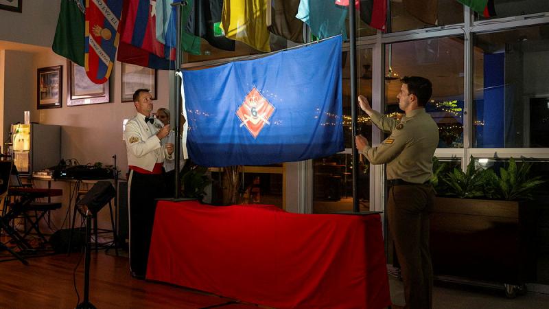 Regimental Sergeant Major 6th Brigade Warrant Officer Class One Gregory Lockett and Corporal Connor Hardy from 6th Engineer Support Regiment lower the 6th Brigade flag at the Montbrehain Dinner.