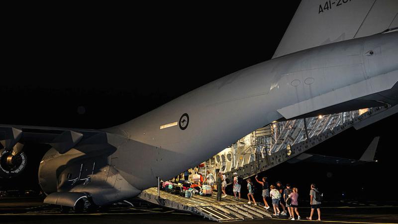 Australian citizens board a RAAF C-17A flight home at Bauerfield International Airport, Port Vila, following the Vanuatu earthquake.