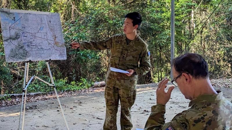 Lieutenant Ian Leung studies a map during a strategic exercise as part of the All Corps Captains Course. 