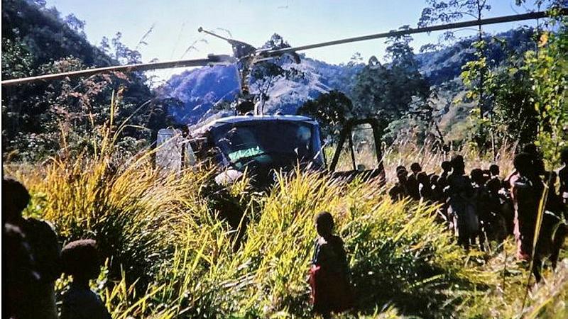 Crew of the A2-487 Iroqouis at a village near Garaina, PNG seeking witnesses to the crash of a RAAF Caribou in August 1972. 