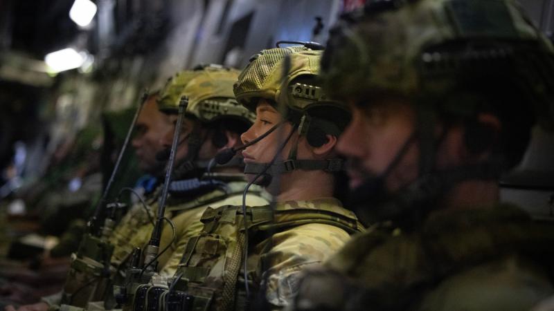 RAAF security aviators on a C-17A Globemaster III prepare for a deployment to the UN Assistance Mission for Iraq Rotation-B.