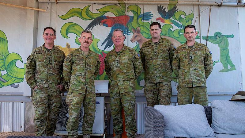 A small group of ADF personnel, including Commander of the Australian Contingent, Colonel Mark Coyle (centre), close off Australia’s commitment to Operation Okra at Aussie House inside US military base Camp Arifjan, Kuwait